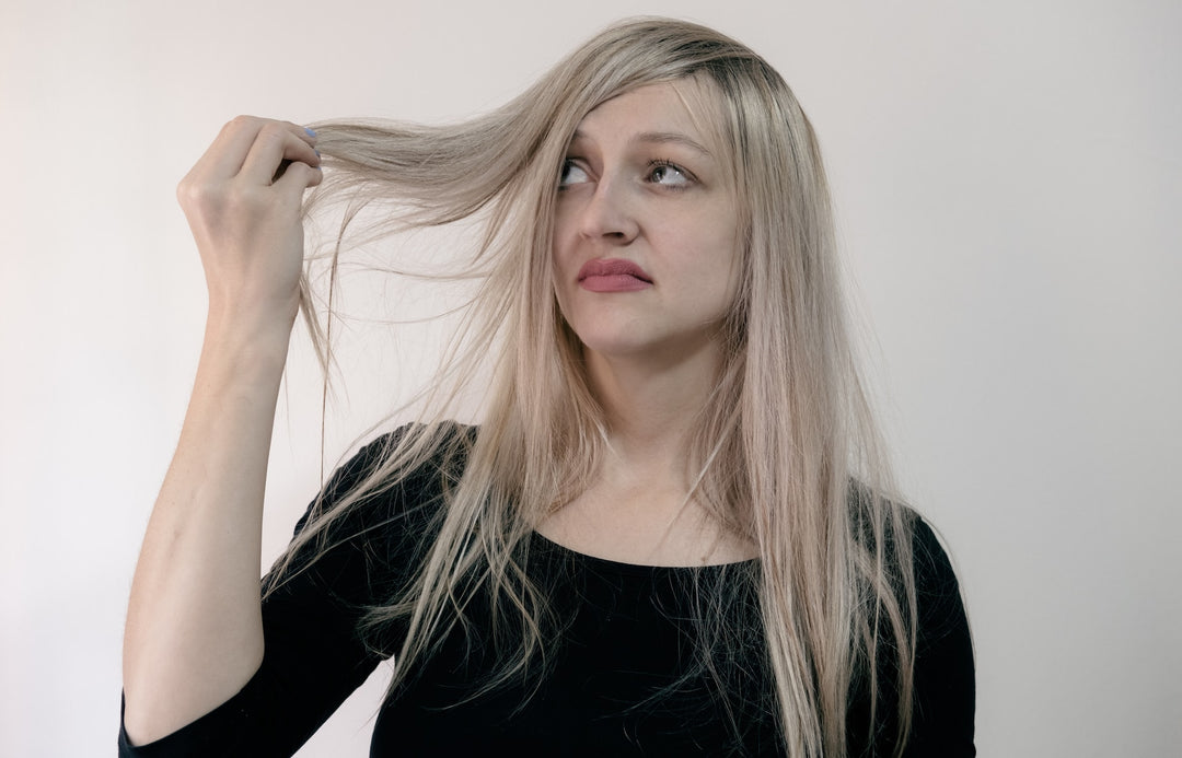 woman holding her dry hair