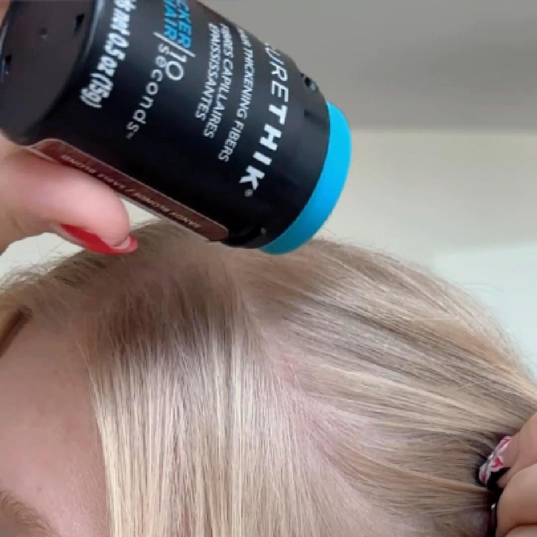 SureThik Hair Thickening Fibers - shaking fibers onto a thinning part