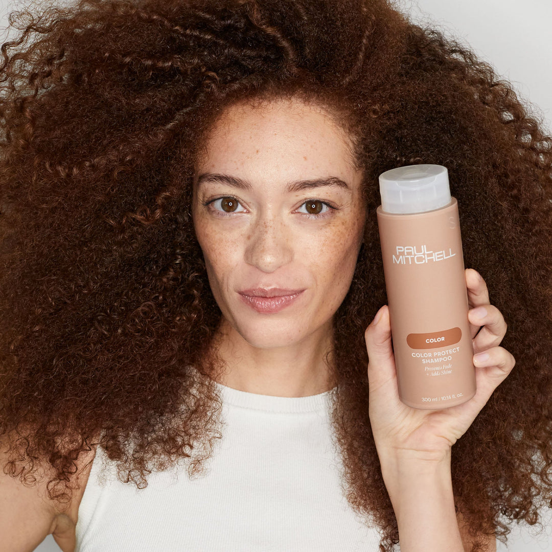 Paul Mitchell Color Protect Shampoo - model holding the bottle