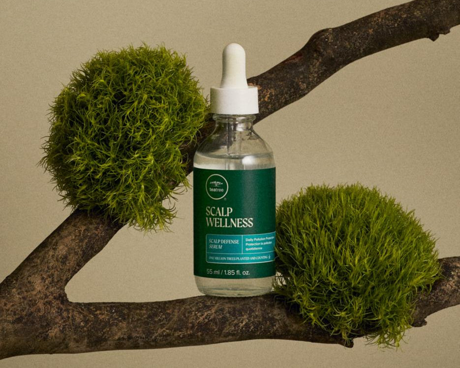 Paul Mitchell Tea Tree Scalp Wellness Scalp Defense Serum - bottle styled on a mossy branch