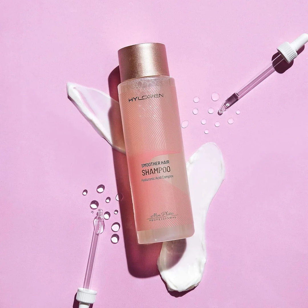 Mon Platin Hyloren Smoother Hair Shampoo - bottle styled on pink with serum drops