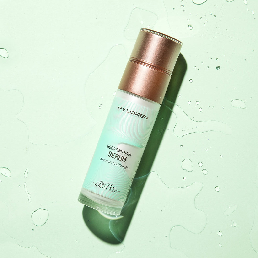 Mon Platin Hyloren Boosting Hair Serum - bottle styled on mint with water drops