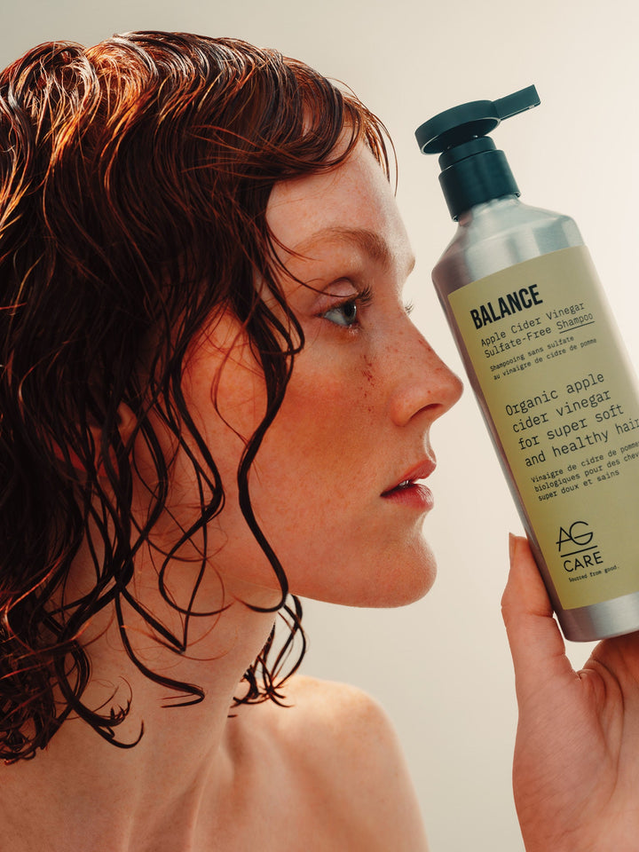 AG Balance Apple Cider Vinegar Sulfate-Free Shampoo - model holding the bottle