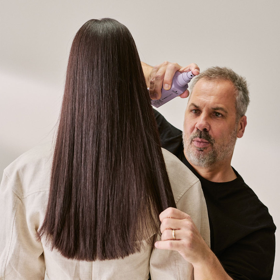 Schwarzkopf Fibre Clinix De-Frizz Smoothing Spray - stylist applying to hair