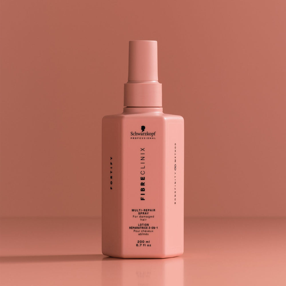 Schwarzkopf Fibre Clinix Fortify Multi-Repair Spray - bottle on coral backdrop