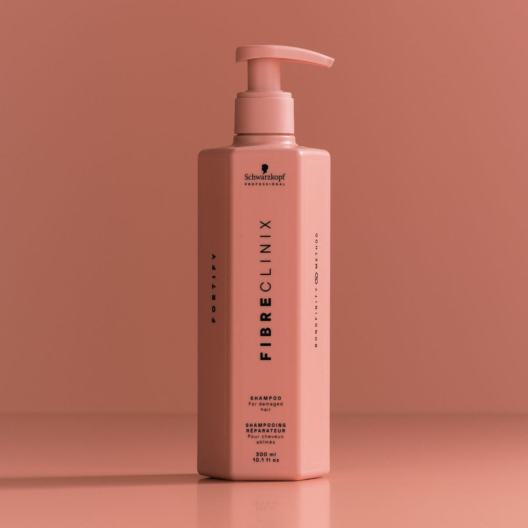 Schwarzkopf Fibre Clinix Fortify Shampoo - bottle on coral backdrop