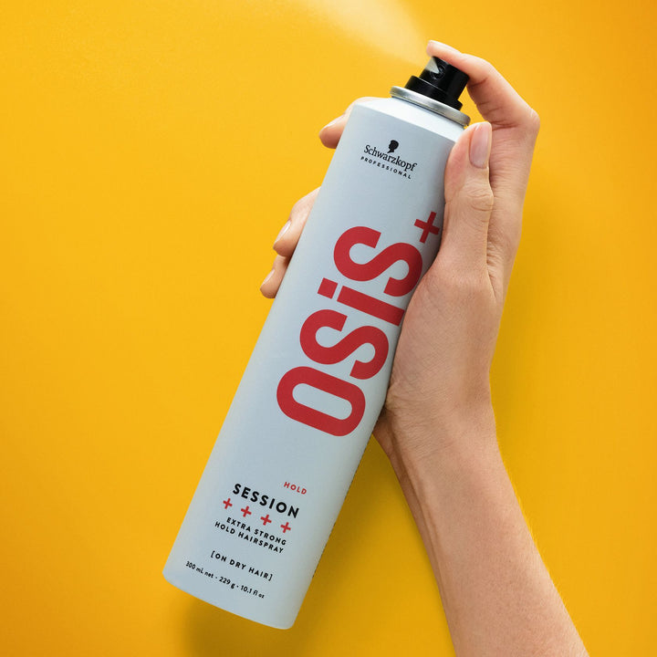 Hand spraying Schwarzkopf OSiS+ Session Extra Strong Hold Hairspray