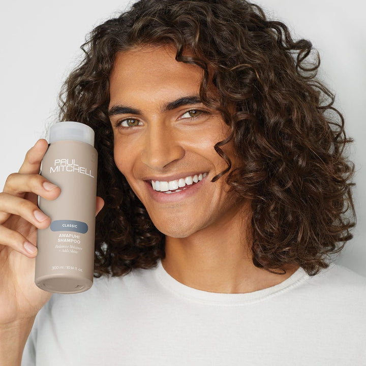 Paul Mitchell Awapuhi Shampoo - model holding the new bottle
